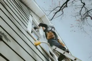 Mammoth Home Renovations installing windows on exterior of house